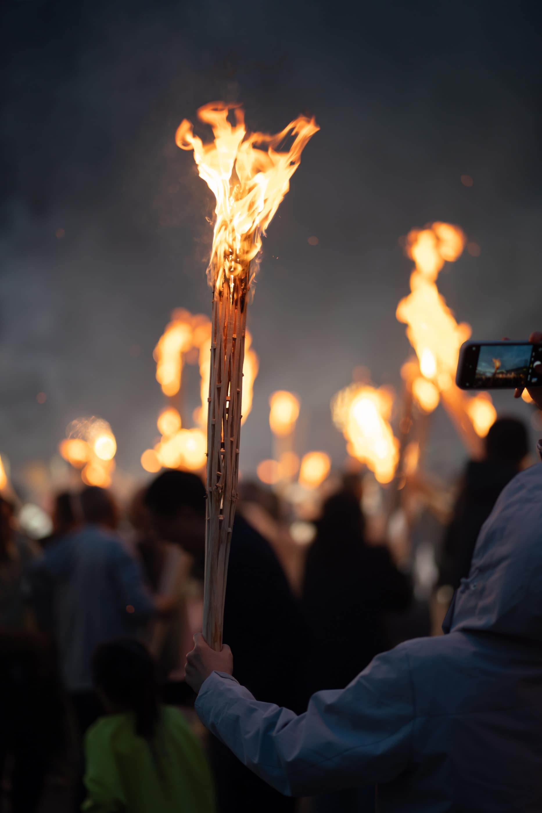 A torch carried through the Dali night